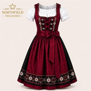 May include: A burgundy dirndl dress featuring a white off-the-shoulder blouse with puffed sleeves. The bodice has a lace-up front with silver-toned hooks, and the skirt displays a floral pattern along the hem. Northfield Treasures logo is visible.
