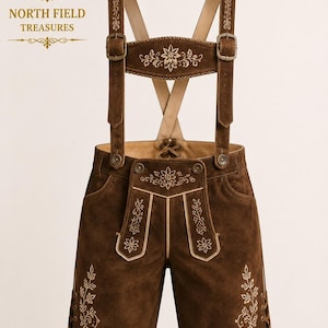 May include: Dark brown leather lederhosen featuring light-colored floral embroidery on the bib, suspenders, and legs. The shorts include adjustable suspenders with metal buckles, a lace-up detail at the sides, and a rear waist lace-up closure.