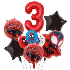 May include: A collection of foil balloons featuring a large red number three, two black star-shaped balloons, and several round and shaped balloons decorated with Spider-Man character graphics in red, blue, black, and white color schemes.