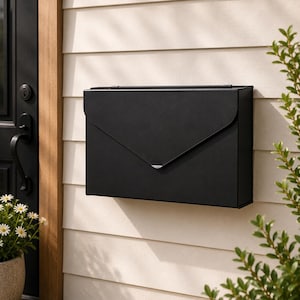 May include: A matte black wall-mounted mailbox with a rectangular body and a pointed, envelope-style flap lid. The mailbox features a clean, minimalist design with a hinged top cover and a smooth, solid finish, mounted securely to a light-colored wall.
