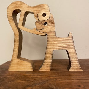 Man’s best friend wooden sculpture. Man’s best friend sculpture. Man and dog wooden sculpture