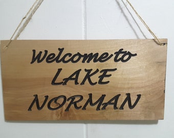 Welcome to Lake Norman reclaimed wooden sign.  Rustic wooden sign saying "Welcome to Lake Norman".  Carved wooden "Welcome to Lake Norman"