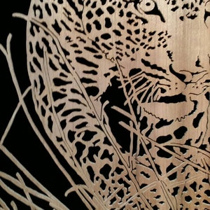Hand cut wooden portrait of a leopard stalking its prey at night image 3