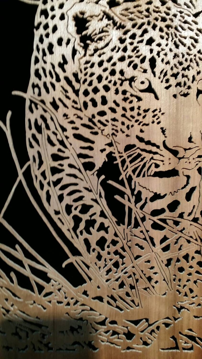 Hand cut wooden portrait of a leopard stalking its prey at night image 3