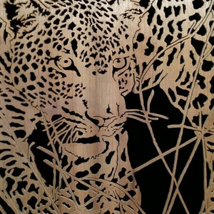 Hand cut wooden portrait of a leopard stalking its prey at night image 2