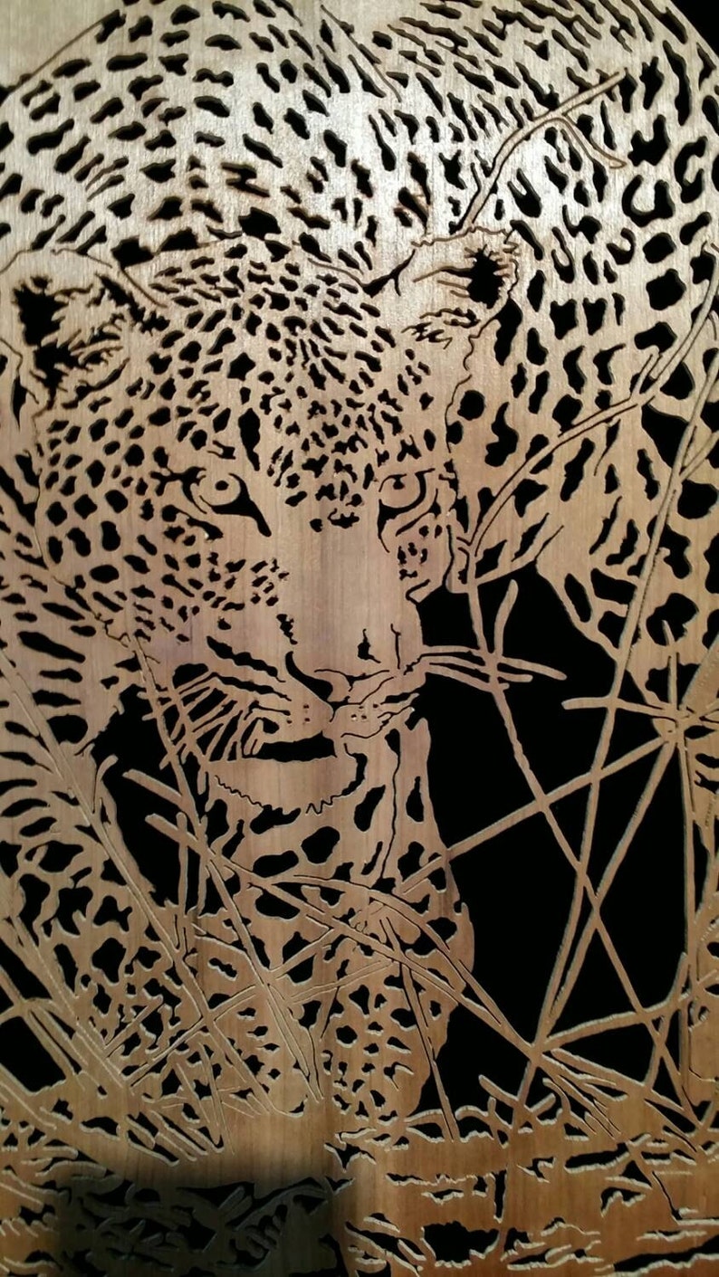 Hand cut wooden portrait of a leopard stalking its prey at night image 2