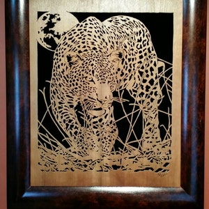 Hand cut wooden portrait of a leopard stalking its prey at night image 1