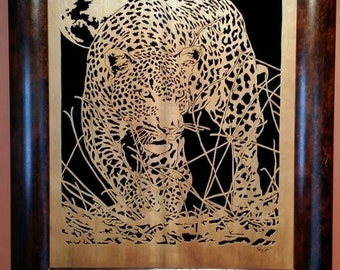 Hand cut wooden portrait of a leopard stalking its prey at night