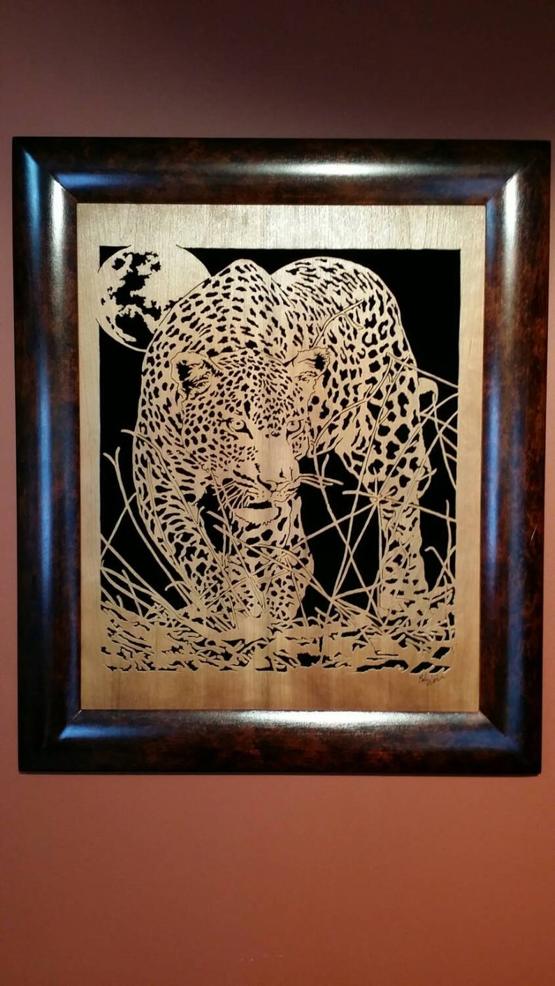 Hand cut wooden portrait of a leopard stalking its prey at night image 1