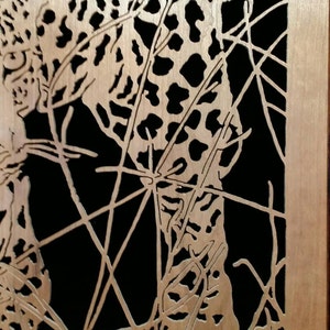 Hand cut wooden portrait of a leopard stalking its prey at night image 5