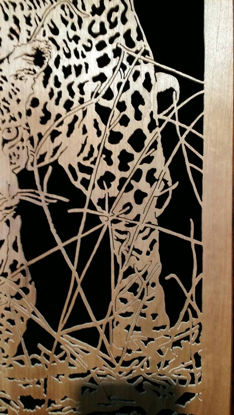 Hand cut wooden portrait of a leopard stalking its prey at night image 5