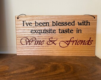 Carved plaque in rustic reclaimed plywood. "I've been blessed with Exquisite taste in Wine & Friends"