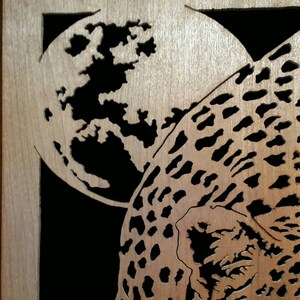 Hand cut wooden portrait of a leopard stalking its prey at night image 4