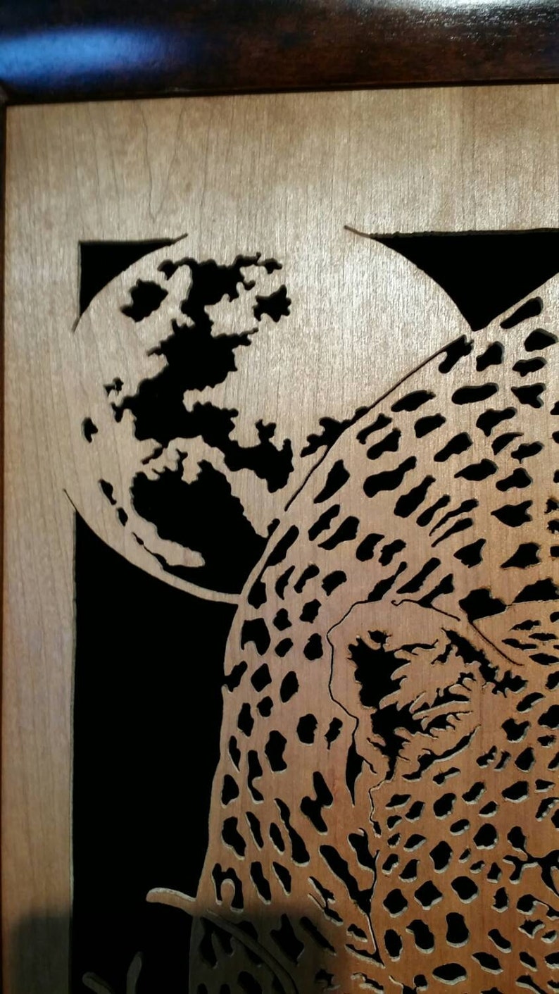 Hand cut wooden portrait of a leopard stalking its prey at night image 4