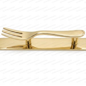 May include: A gold-coloured metal cabinet handle shaped like a fork. The handle features a horizontal rectangular base plate with two vertical supports connecting to a fork-shaped top piece, all finished in a smooth, polished, reflective metallic gold.