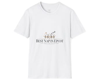 May include: A white short-sleeve t-shirt featuring a central graphic of three theater seats with a sleeping face and ZZZ symbols. Below the graphic, the text reads BEST NAP IN EPCOT THE AMERICAN ADVENTURE 1982 in a clean, dark serif font.