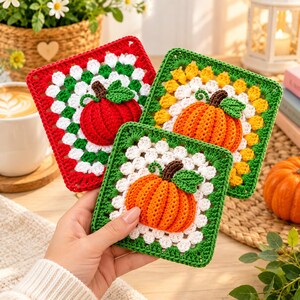 May include: Three square crochet granny squares featuring a central three-dimensional pumpkin motif. Each square has a white inner border and a colored outer border in red, yellow, or green, with green leaves and brown stems on the pumpkins.