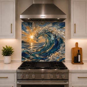 May include: A square kitchen backsplash panel featuring a mosaic-style artistic depiction of a large ocean wave crashing at sunset. The design incorporates deep blue, gold, and white tones with a sunburst effect reflecting on the water surface.