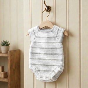 May include: A sleeveless knitted romper featuring horizontal white and light gray stripes. The garment has a round neckline, a textured stitch pattern, and three small white buttons at the bottom closure, hanging on a wooden hanger.