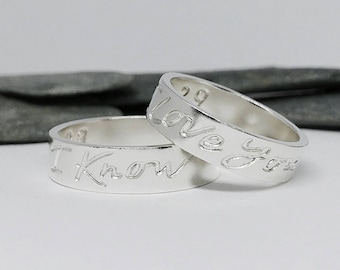May include: Two silver rings with the words "I Know" and "Love You" engraved on them.