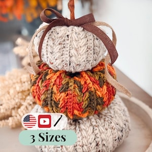 Three stacked crochet pumpkins in speckled oatmeal and orange-green with braided texture and a brown ribbon bow