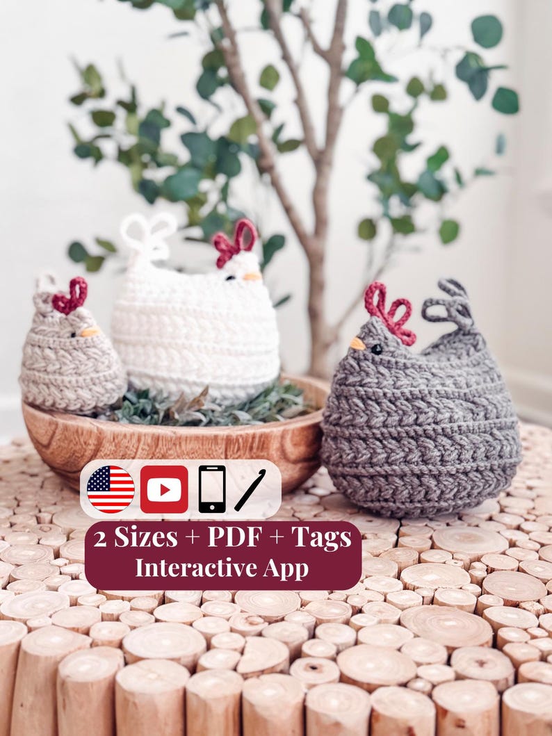 Three crochet chickens in oatmeal, cream, and gray with red combs, two in a wooden bowl on a log slice table