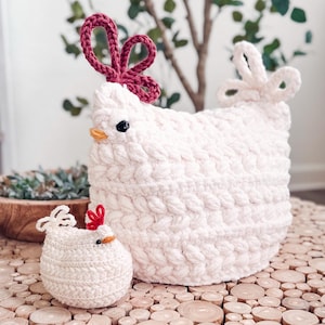 Large and small white crochet chickens with red combs and braided texture sitting on wood slices