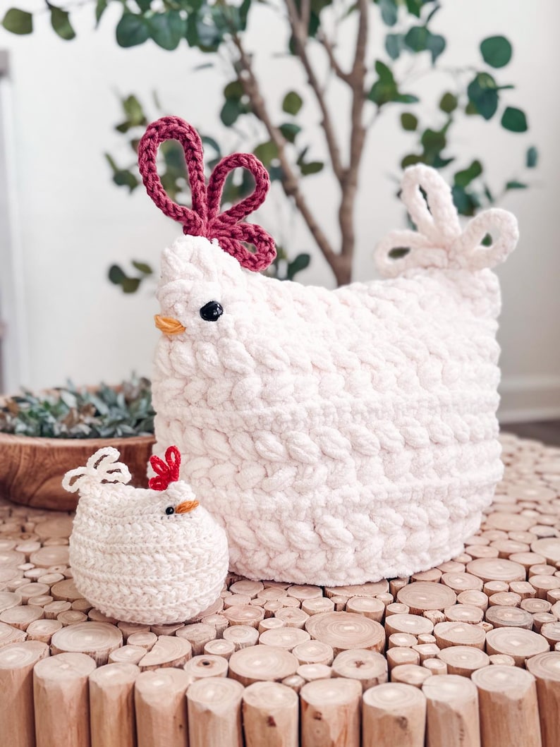 Large and small white crochet chickens with red combs and braided texture sitting on wood slices