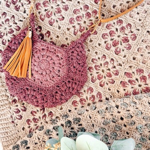 A handmade crocheted purse with a tassel, perfect for a unique gift or vintage fashion accessory.