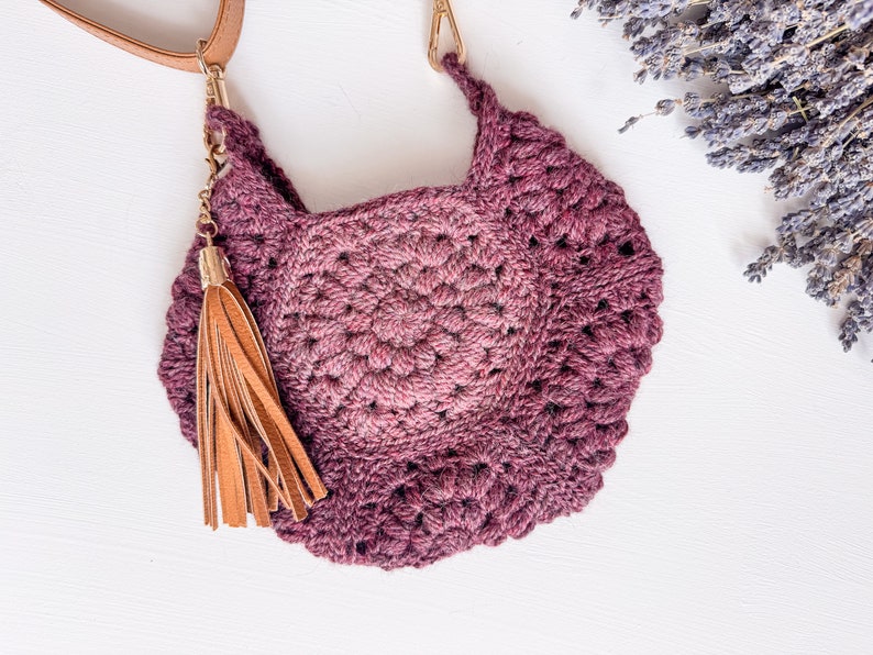 A handmade gift featuring a crocheted bag with a wooden handle.