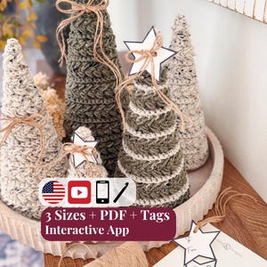 May include: A collection of five cone-shaped crochet trees in olive green and speckled cream yarn, each adorned with a jute twine bow. Some trees feature white star-shaped paper tags. A spool of jute twine and a sheet of star tags are included.
