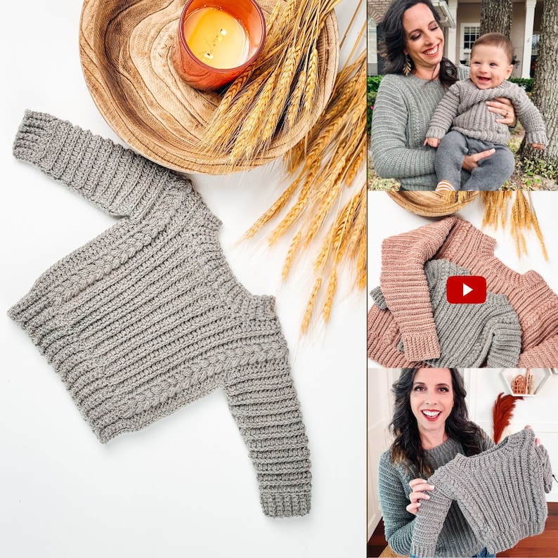 May include: A gray, ribbed-knit sweater with long sleeves. The sweater is displayed on a white surface, with a wooden bowl, candle, and wheat stalks in the background. The image also shows a woman and a baby wearing similar sweaters.