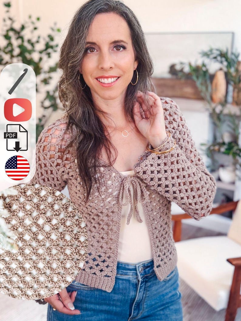 May include: A beige crochet cardigan featuring a repeating openwork diamond pattern, long sleeves, and a front tie closure. The garment has a ribbed hem and cuffs, with a detailed circular inset showing the intricate texture of the yarn stitches.