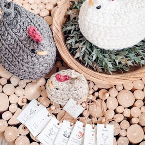 Gray, white, and oatmeal crochet chickens seen from above with a row of printable chicken gift tags