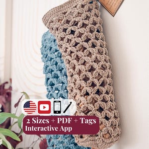 May include: Two hanging crochet plastic bag holders in beige and blue, featuring an open lattice stitch pattern. A brown paper tag is attached to the beige holder with text. A graphic overlay displays the text 2 Sizes + PDF + Tags Interactive App.