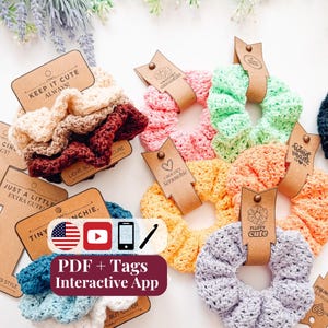 May include: A collection of crocheted hair scrunchies in various colors including cream, maroon, pink, light green, orange, yellow, blue, and lavender. Each scrunchie is attached to a brown cardboard tag with printed text and a small metal rivet.