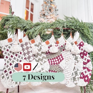 May include: Seven crochet Christmas stockings in various designs, displayed on a brown metal rack with greenery. Each stocking features a unique pattern in white, gray, and burgundy, with a cream tassel and leather tag. The text "7 Designs" is visible.