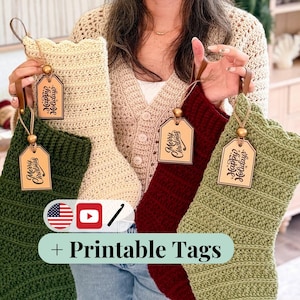 May include: Four crocheted Christmas stockings in cream, dark green, burgundy, and sage green. Each stocking features a leather hanging loop, a wooden bead, and a rectangular wooden tag engraved with either Merry Christmas or Happy Holidays.
