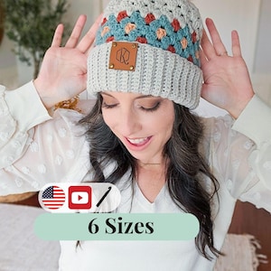 May include: A handmade crochet beanie with a light grey brim and a patterned crown in teal, orange, and peach. The hat features a brown leather tag with a logo and a large orange faux fur pom-pom. The text "6 Sizes" is displayed below the hat.