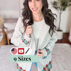 May include: A cream-colored, open-front crochet cardigan with colorful floral accents on the sleeves. The cardigan is worn by a person. The image includes text that says "9 Sizes".