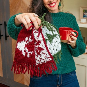 May include: Three crocheted Christmas tree ornaments with white and red, white and green, and white and brown patterns. The ornaments have fringe at the bottom.