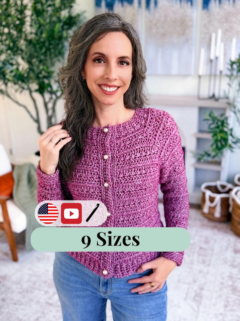 May include: A magenta crochet cardigan with pearl buttons. The image includes the text "9 Sizes" on a green banner. The cardigan is worn with blue jeans. The background includes greenery and a fireplace.
