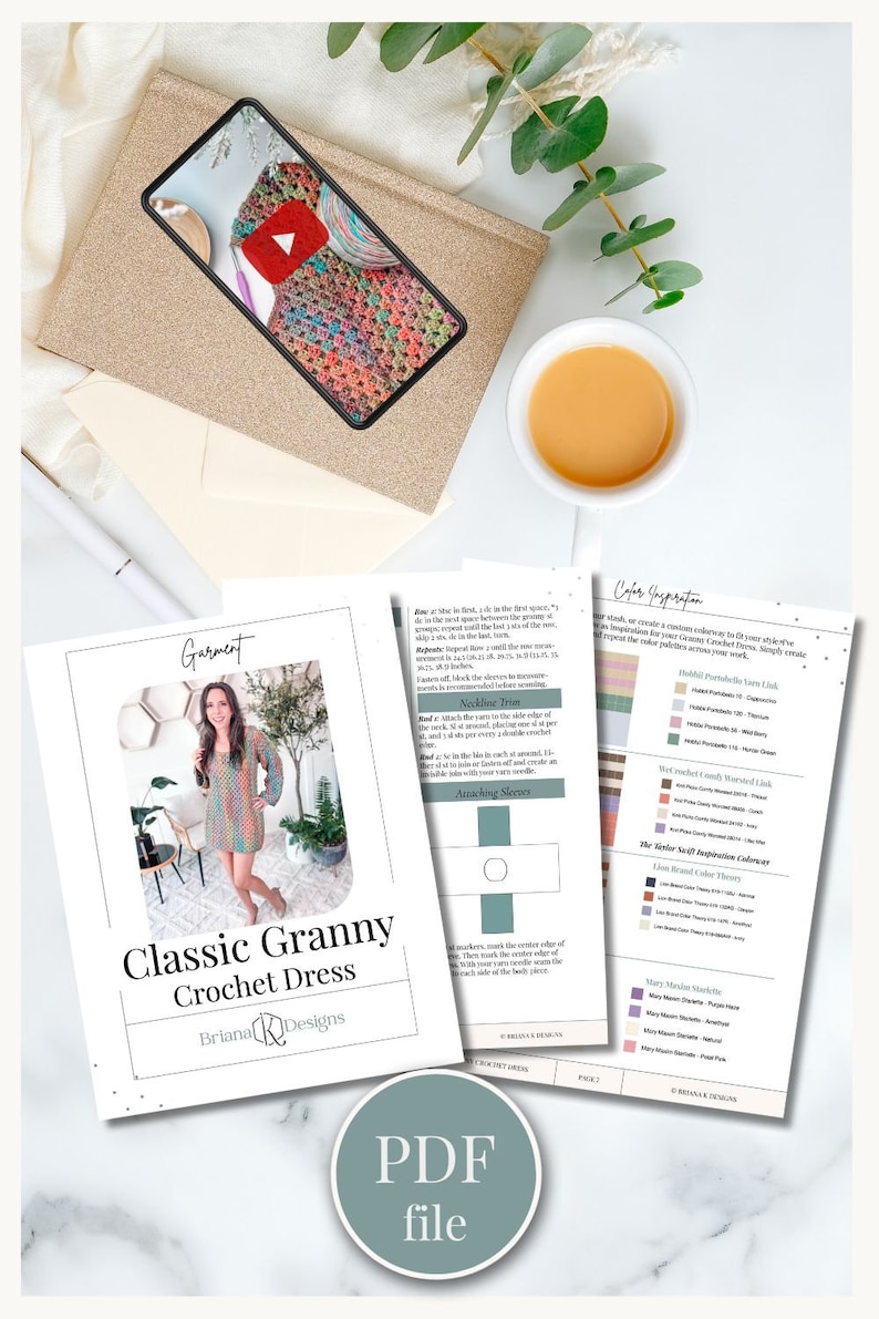 Flat lay image featuring a PDF pattern for a crochet dress, a smartphone displaying the dress, a cup of tea, an envelope, and green foliage. The scene has a charming vibe reminiscent of vintage clothes and makes for an exquisite handmade gift.