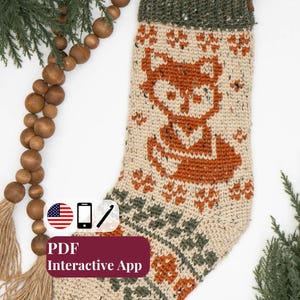 May include: A cream-colored crocheted Christmas stocking featuring a rust-orange fox graphic and dark green accents. The stocking has a ribbed cuff and a brown leather hanging loop. Text on the image reads PDF Interactive App.