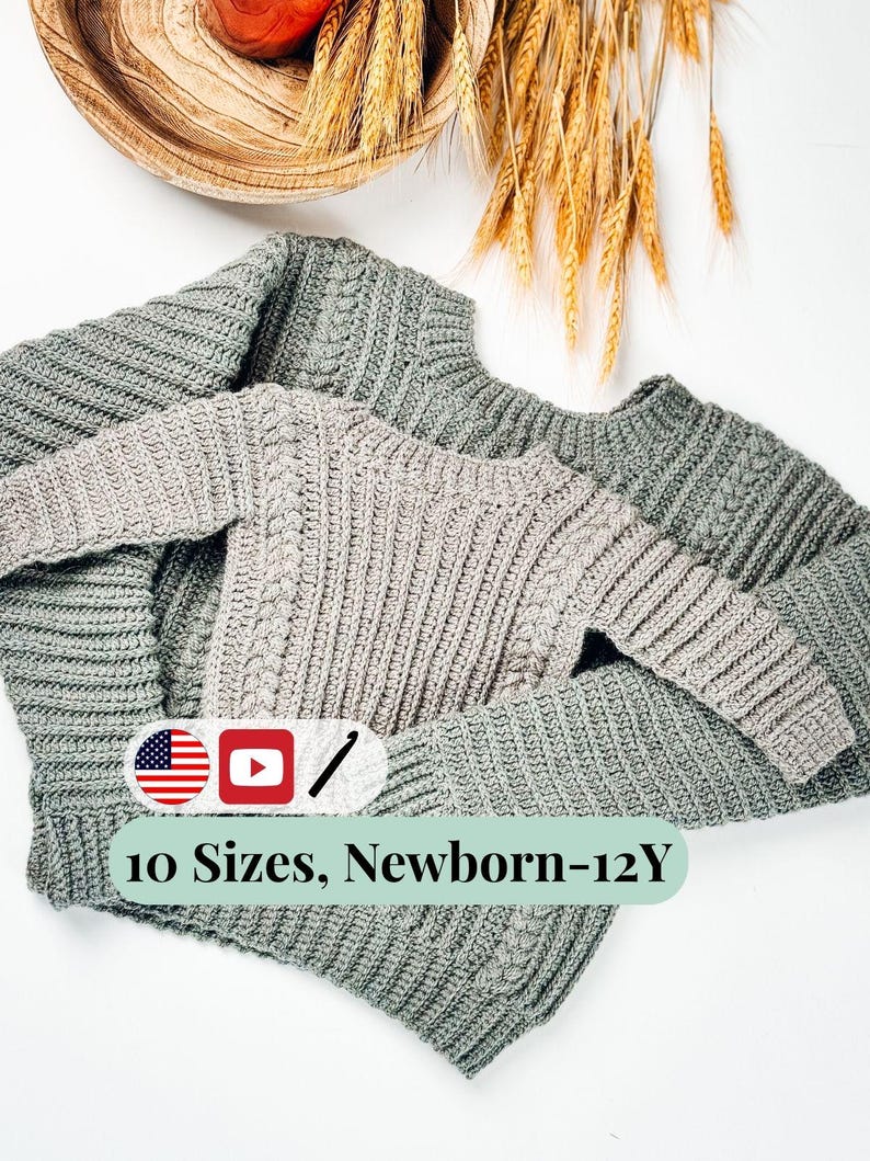 May include: Two gray knitted sweaters, one larger and one smaller, are displayed on a white surface. The sweaters have a textured cable knit design. Text on the image reads "10 Sizes, Newborn-12Y".
