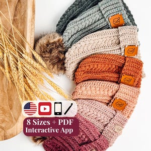 May include: A stack of seven crocheted beanies in various colors including dark gray, light gray, beige, rust, peach, light pink, and dark pink. Each beanie features a cable knit pattern, a folded brim, and a brown leather tag. Text reads 8 Sizes + PDF Interactive App.