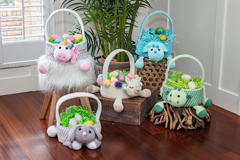 Set of crochet easter baskets in bright colors including a unicorn, bunny, llama, dinosaur and dragon.