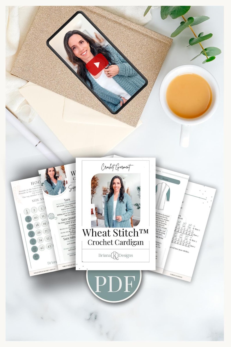 May include: A flat lay featuring a smartphone displaying a video, a stack of crochet pattern instructions, and a cup of tea. The pattern instructions are for a "Wheat Stitch Crochet Cardigan" by Briana K Designs, available as a PDF.