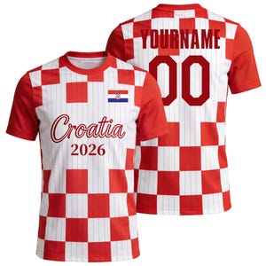 May include: A short-sleeved t-shirt featuring a red and white checkered pattern with thin vertical pinstripes. The front displays the text Croatia 2026 and a small Croatian flag. The back shows the text YOURNAME above the number 00 in dark red.