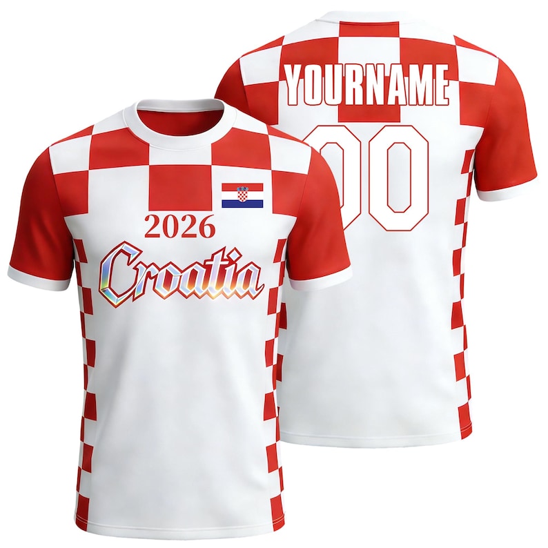 May include: A short-sleeved t-shirt featuring a red and white checkered pattern on the sides and shoulders. The front displays the text 2026, the word Croatia in a metallic font, and a small Croatian flag. The back shows YOURNAME and 00.